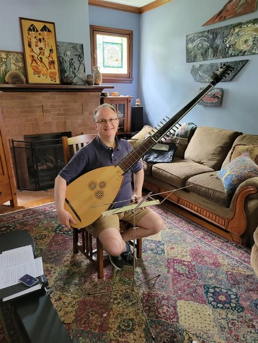 Musician Sean Ferguson with a theorbo